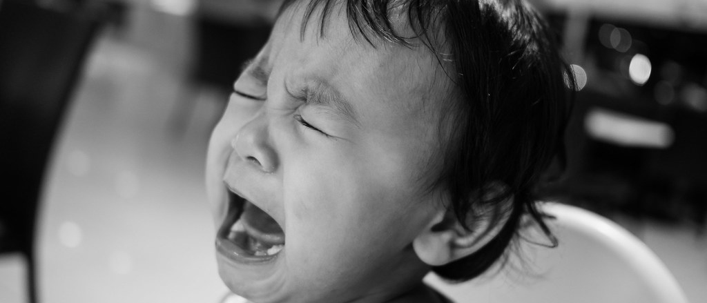 Black and white image of baby crying